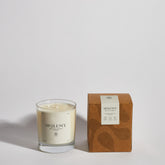 Boujie Opulence luxury soy wax jar candle, front view with packaging, handmade with natural soy wax in a clear glass jar, scented with dark honey, patchouli, and tobacco.